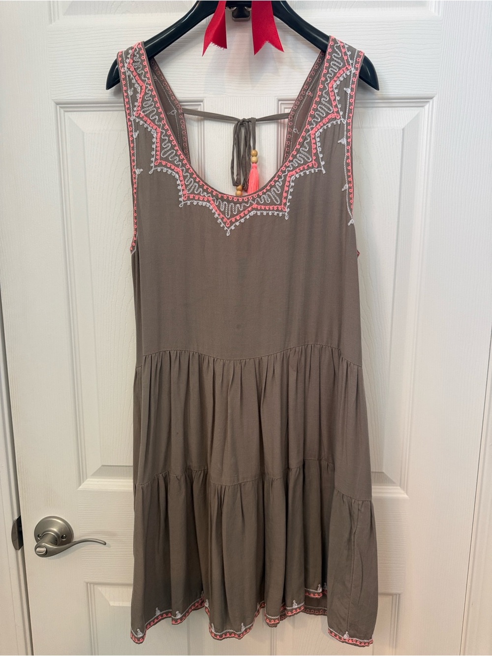Unique Taupe Sleeveless Tiered Mini Dress with Pink Embroidery and Tassels.